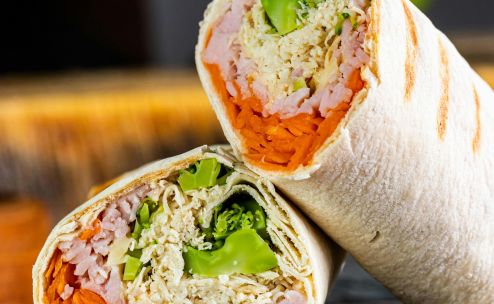 Fresh wraps filled with chicken, vegetables, and cheese, perfect for a healthy meal.