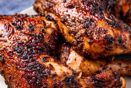 Appetizing barbecue chicken wings served with rich dipping sauce on rustic wooden board.