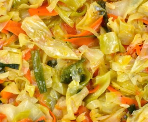 Delicious fried fish with rice, plantains, and fresh salad on a white plate.