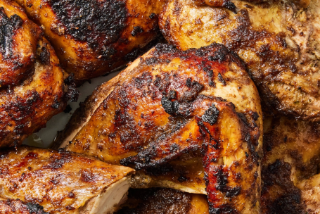 Golden-brown chicken wings garnished with fresh herbs, perfect for a tasty meal.