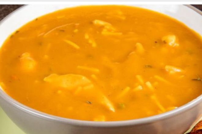 A hearty Vietnamese soup served with fresh baguette and condiments, perfect for lunch.